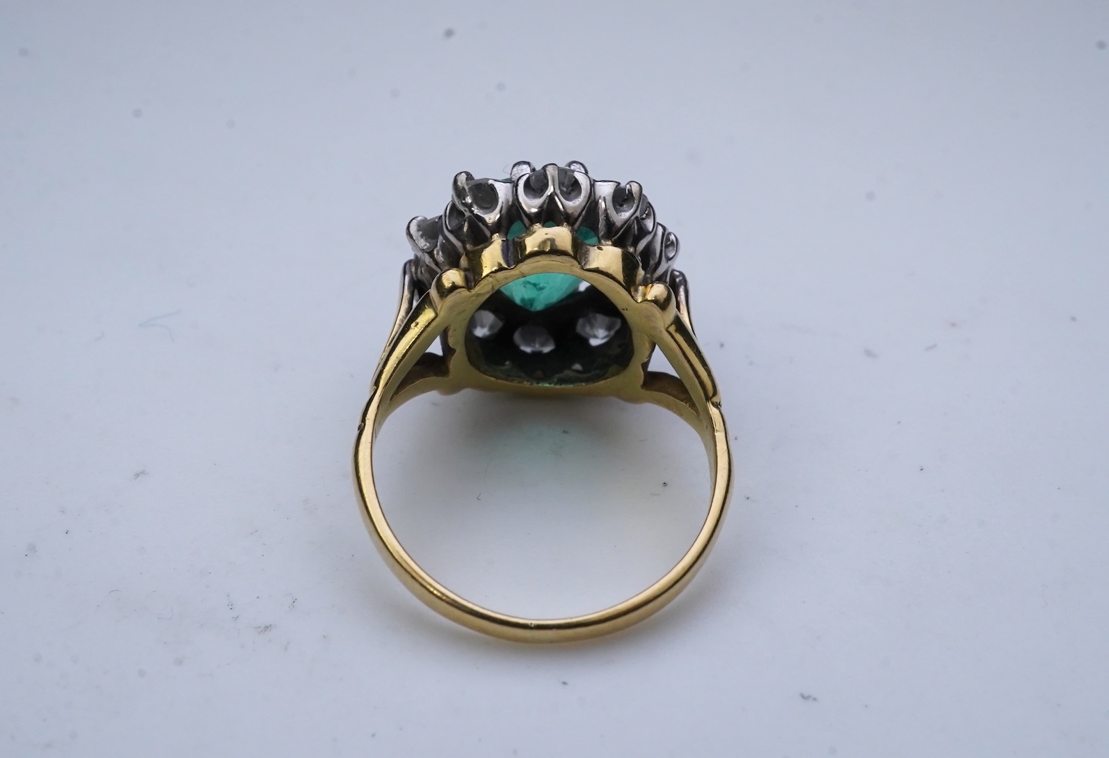 An emerald and diamond ring